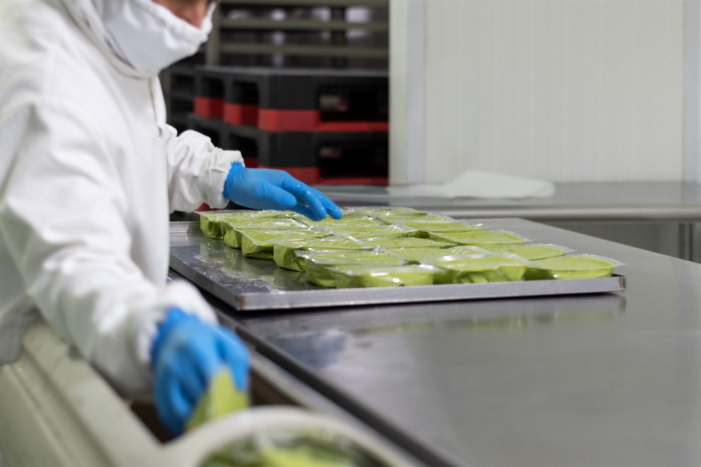 An operator arranging trays of guacamole on the packing line