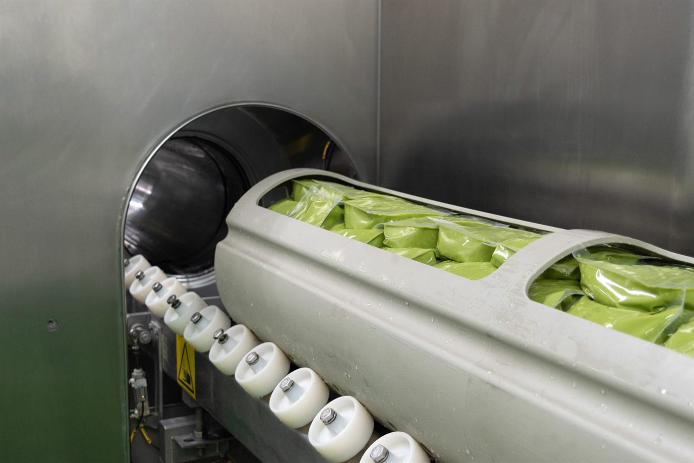 Pouches of guacamole entering the high pressure processing machine