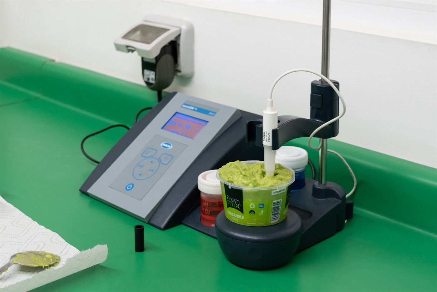 A guacamole sample being tested with laboratory instruments on the production line