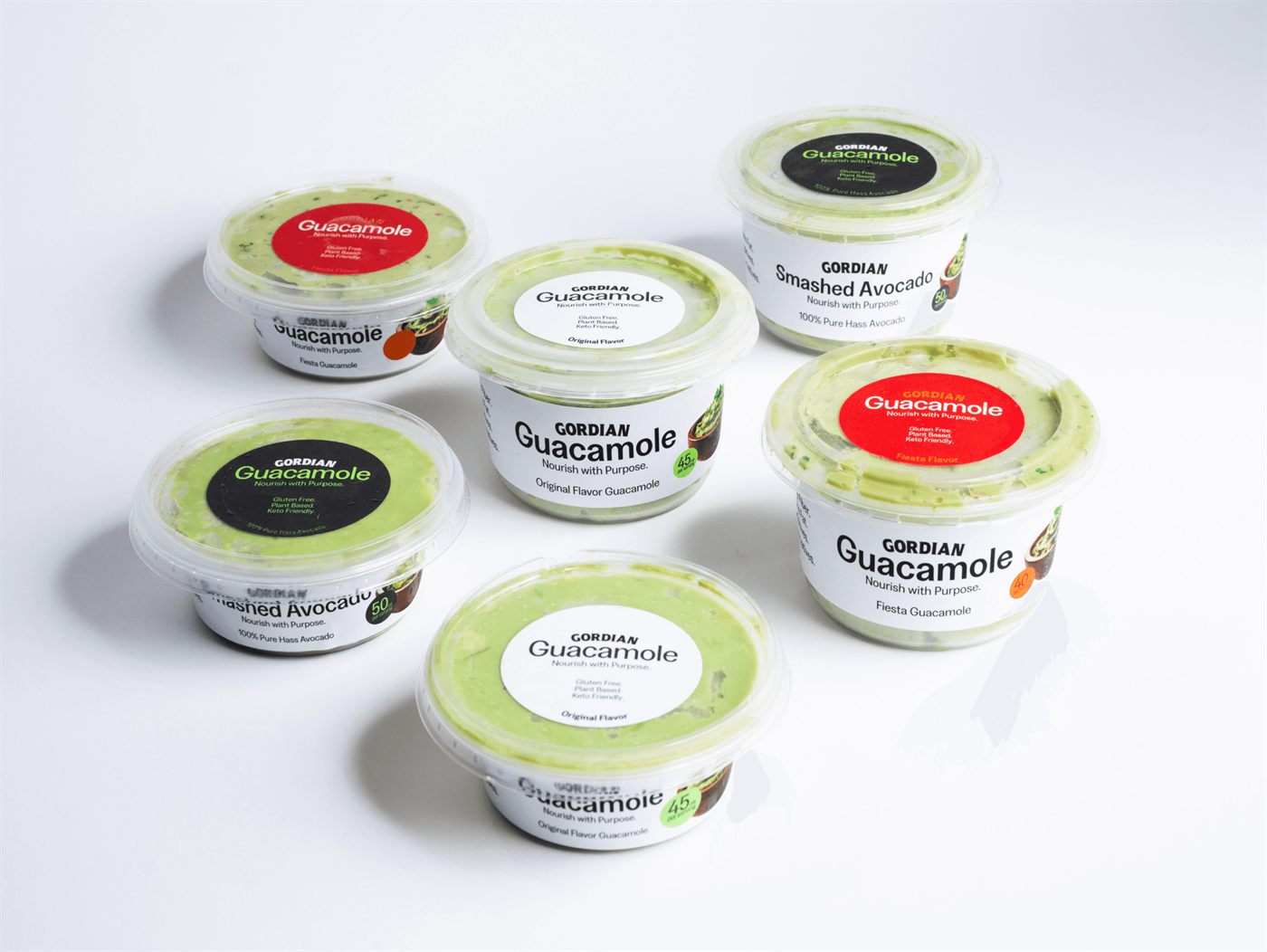 The Gordian range of guacamole and smashed avocado cups arranged on a white surface